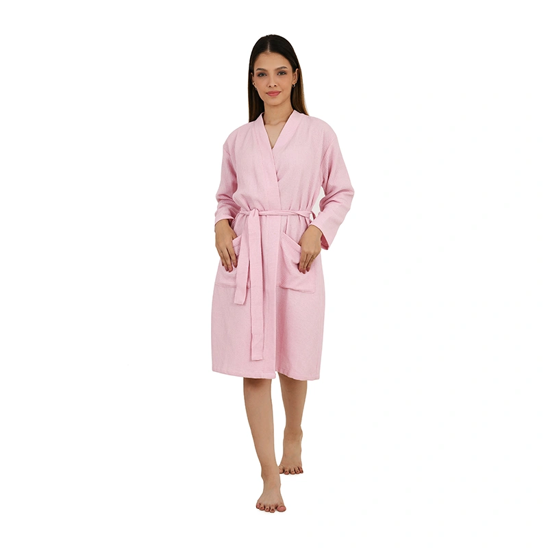Pink waffle-textured knee-length bathrobe with tie belt and front pockets - loungewear ecommerce photography by Lohar Studio Delhi
